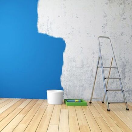 An empty room with blue paint and a ladder.